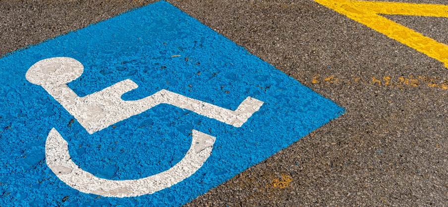 A blue and white sign on a road

Description automatically generated