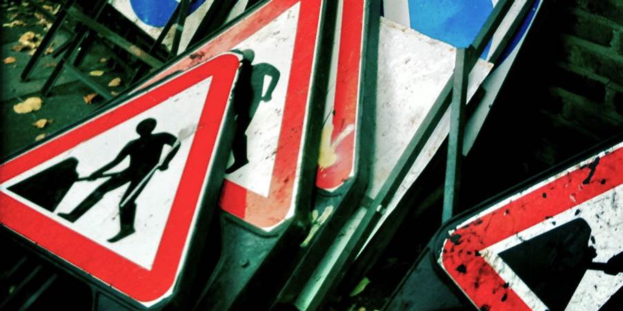 Close-up of a pile of road signs

Description automatically generated