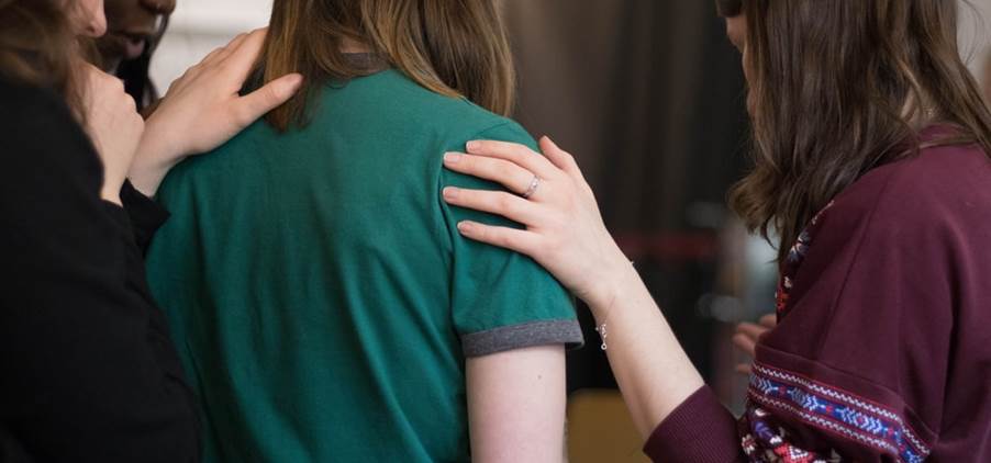 four women looking down
