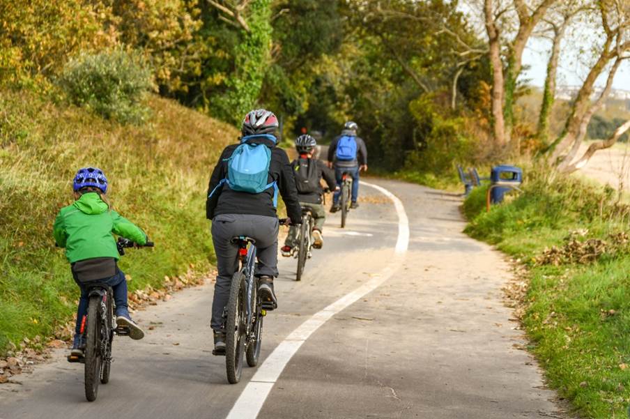 A group of people riding bicycles on a road

Description automatically generated