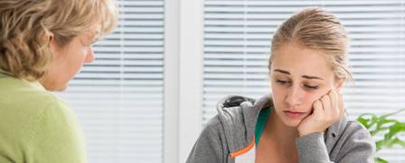 concerned teenage girl talking to a woman