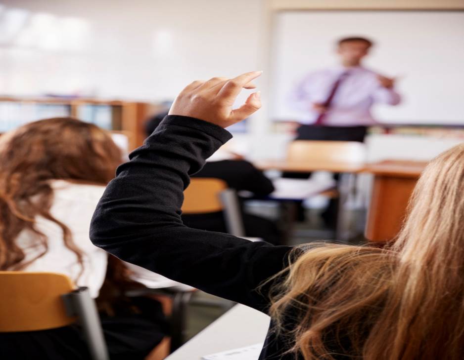 A close-up of a person raising her hand