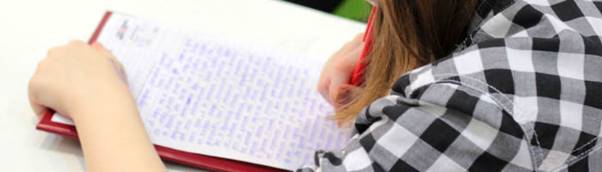 A young woman writing in an exam 