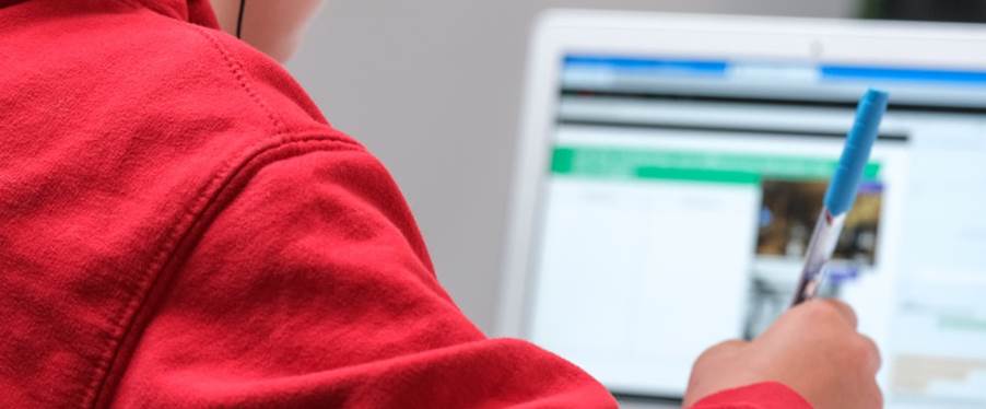 person in red shirt wearing black and gray headphones