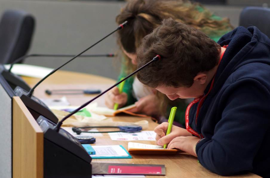 A group of people writing on a notebook
AI-generated content may be incorrect.