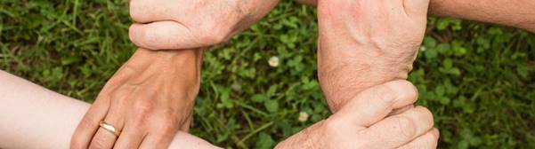 A group of hands holding each other

Description automatically generated with low confidence