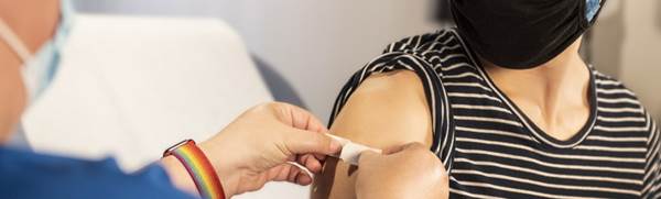 person in blue long sleeve shirt holding white textile
